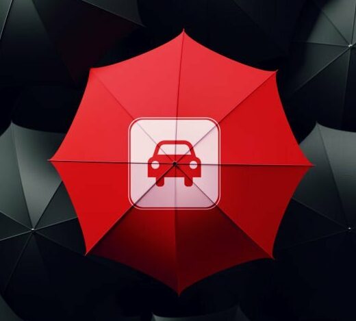 Red umbrella surrounded by black umbrellas, The red umbrella has a car insurance icon on it. Horizontal composition with copy space. Directly above. Great use for car insurance concepts.